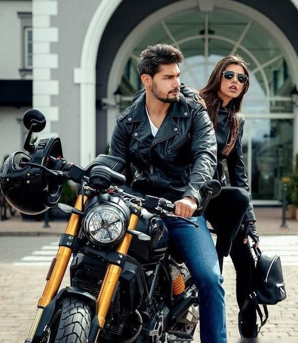 A young Indian couple in leather jackets with their newly financed motorcycle
